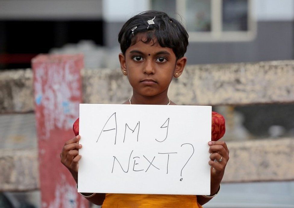 girl holds a placard during a protest against the rape of an eight-year-old girl in Kathua, near Jammu, in Kochi, India April 15, 2018.