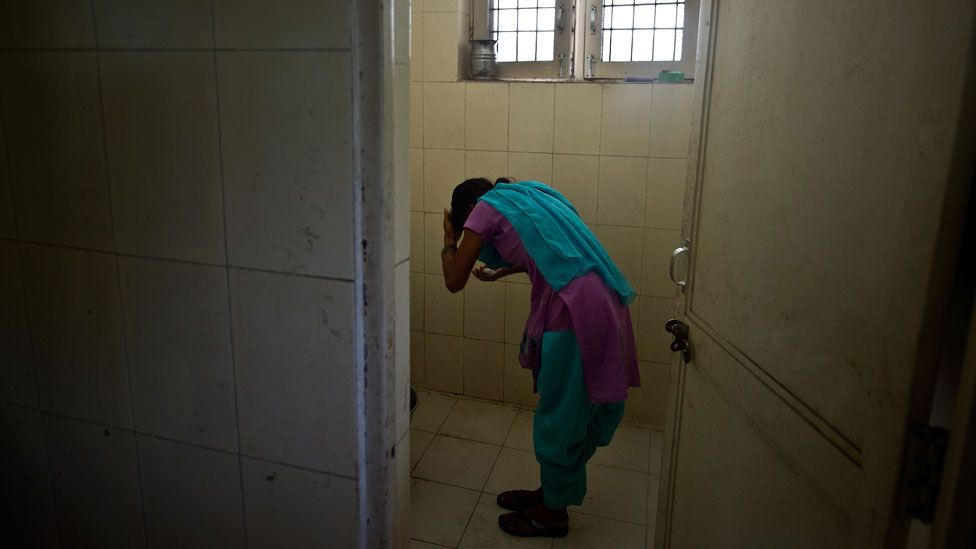 A child washes in a police station after being rescued from traffickers