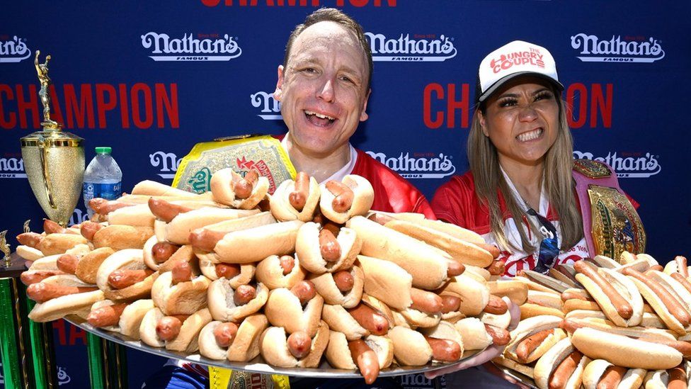 Joey Chestnut from Indiana (L) and Miki Sudo from Florida (R) with hot dogs