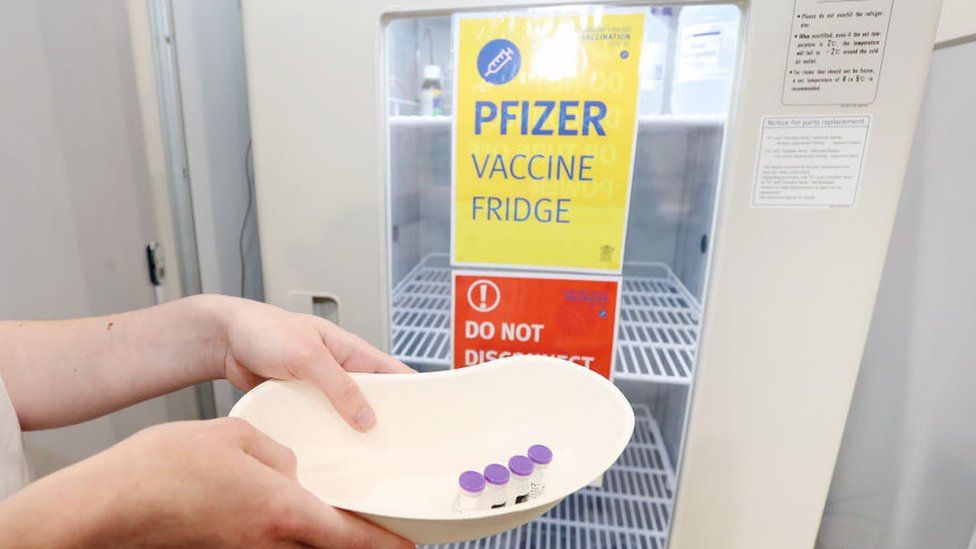 Pharmacy Lead Sarah Spann is seen with Pfizer vials on opening day of the COVID-19 vaccination hub