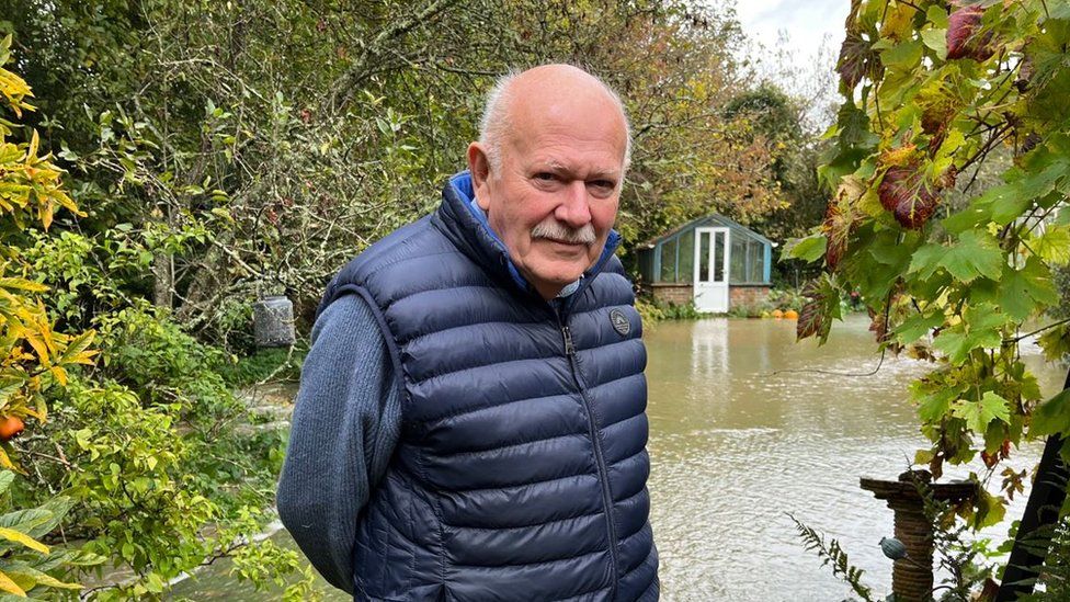Colin Tourle standing in front of his flooded garden in Hellingly