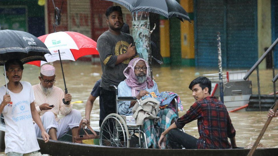 People try to survive as monsoon rains swamped huge areas of the country, leaving millions of homes underwater in Sylhet, Bangladesh on June 18, 2022.