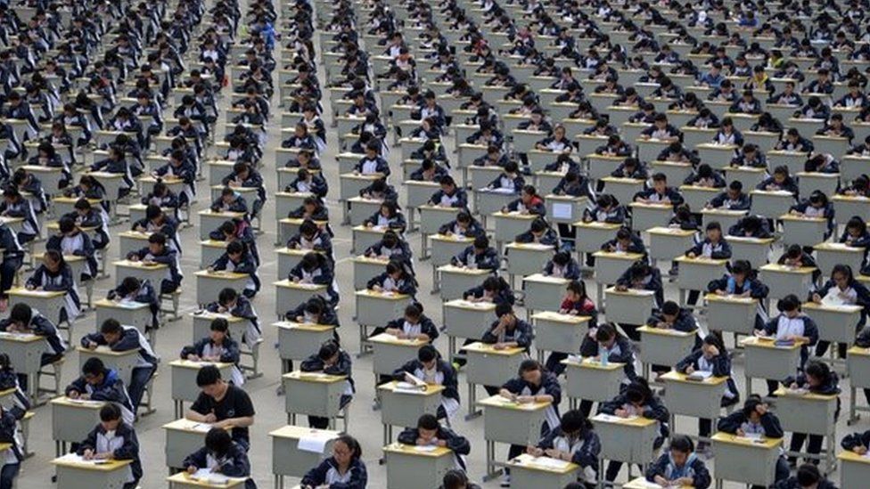 Students take an examination on an open-air playground at a high school in Yichuan, Shaanxi province 11 April 2015.
