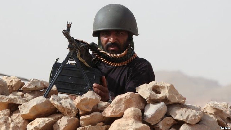 A soldier loyal to Yemeni President Abd-Rabbu Mansour Hadi takes position at an army post in al-Abr on Yemen's north-eastern border with Saudi Arabia
