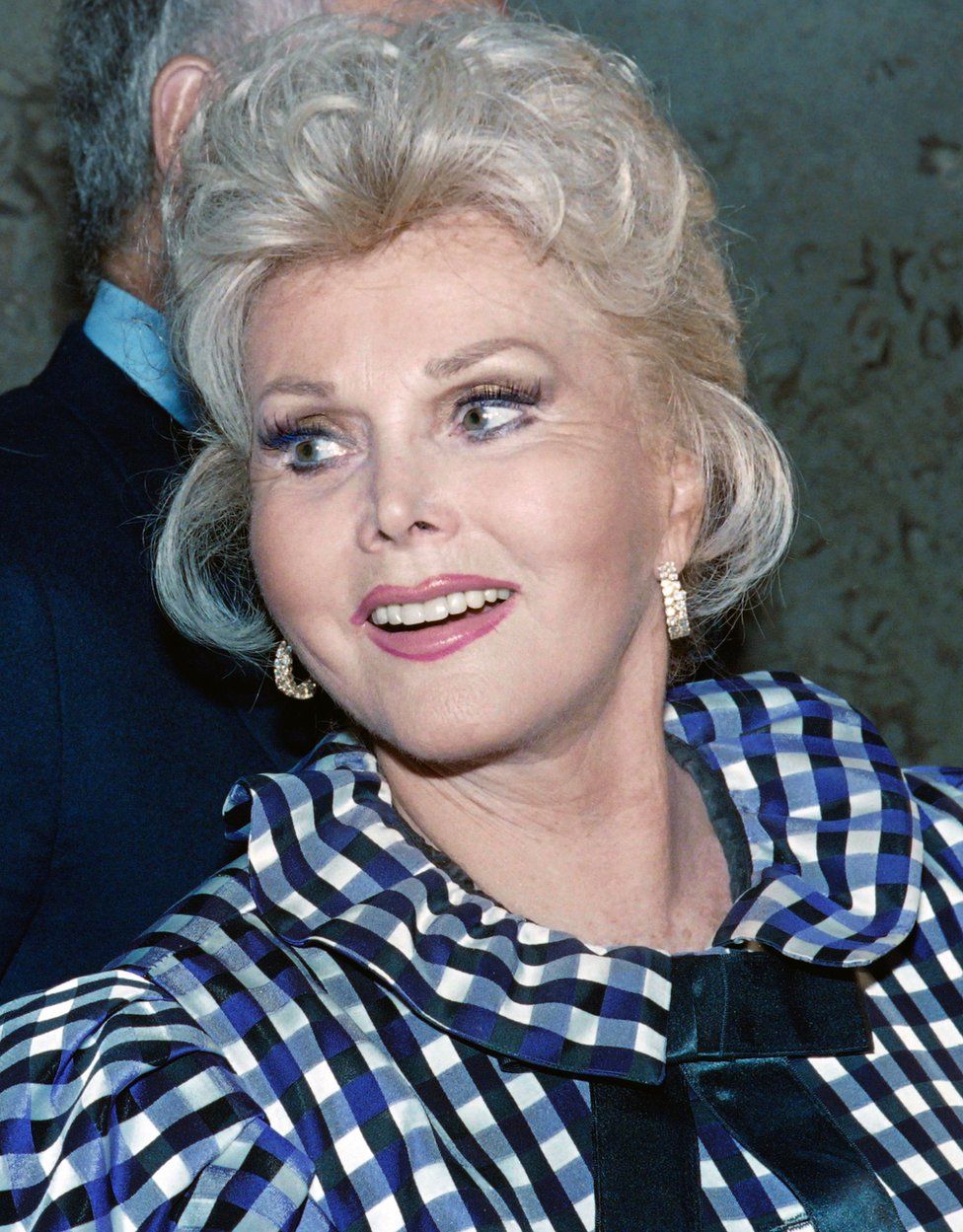 This file photo taken on July 12, 1989 shows US actress Zsa Zsa Gabor exiting the Beverly Hills Municipal Court on July 12, 1989 where she appeared in order to answer charges of battery against a police officer.