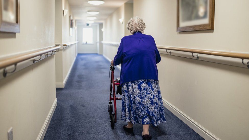 Woman with a frame in a care home
