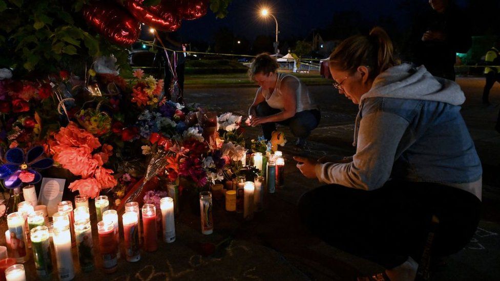 Residents held a candlelight vigil on Sunday near the site of the shooting
