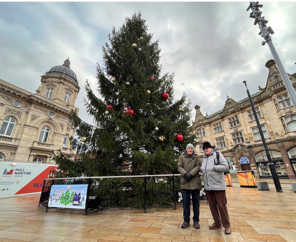 Graham pictured with his coach Geoff in Hull city centre. They are standing in front of a Christmas tree.