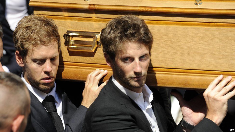 German F1 driver Sebastian Vettel (left) and France's Romain Grosjean join pallbearers carrying the coffin of Jules Bianchi during his funeral held at the Cathedral of Sainte Reparate, in Nice, France, 21 July 2015