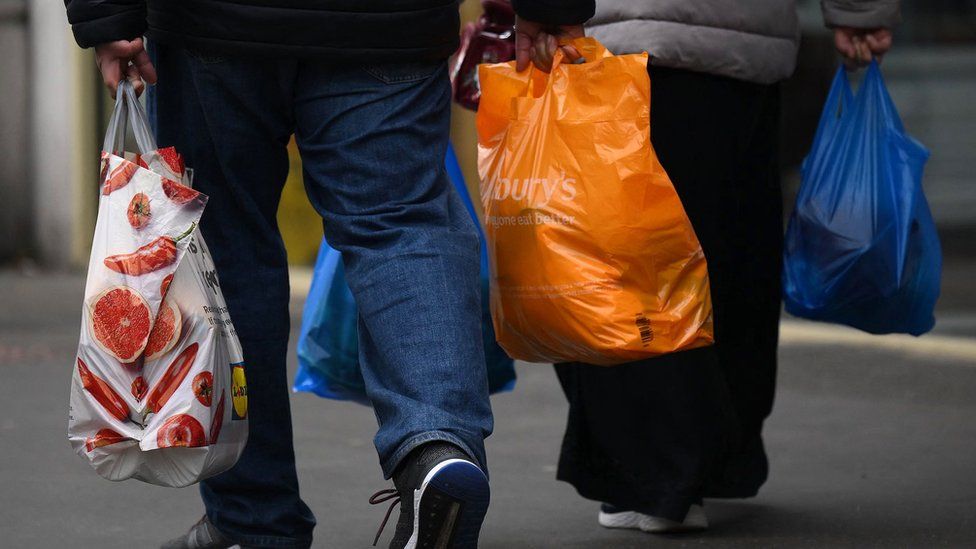 Shoppers with Sainsbury's carrier bags