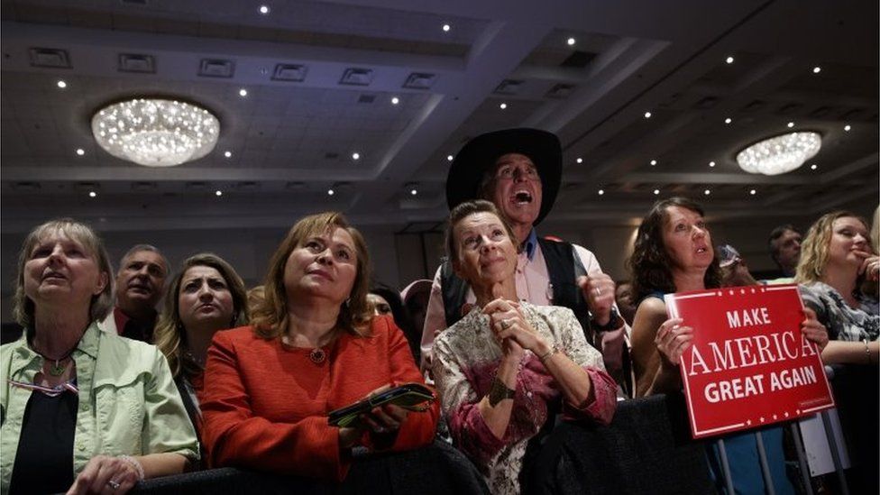 Supporters of Republican presidential candidate Donald Trump cheer during a campaign rally.