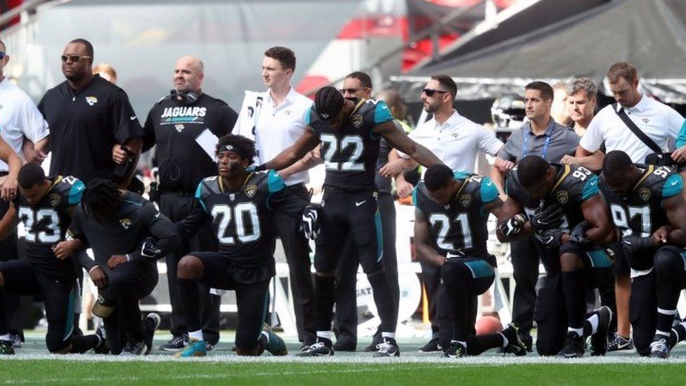 Members of the Jacksonville Jaguars kneel and lock arms in protest during the national anthem before the NFL International Series match at Wembley Stadium in London.