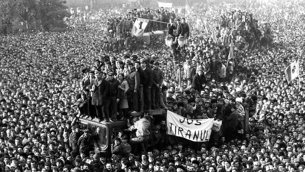 Romanian demonstrators gather in front of the headquarters of the Romanian Communist Party in Bucharest, Romania, on 22 December 1989