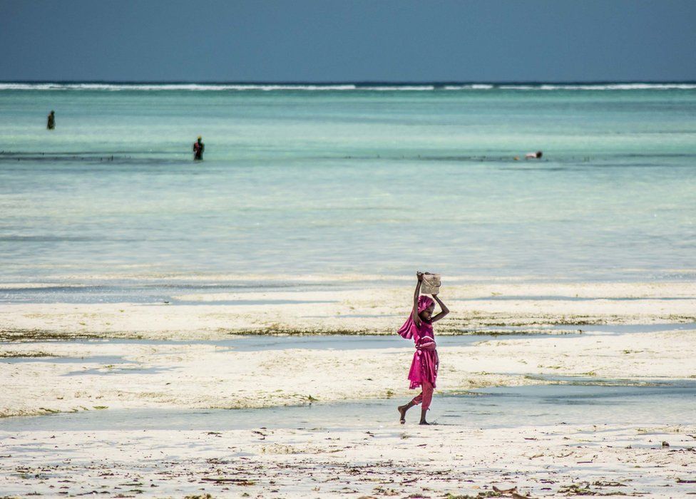 A young girl returns to shore at Paje Beach