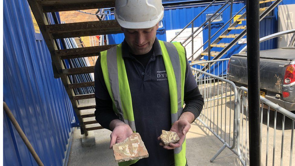 : Friary site supervisor Andrew Shobbrook with medieval tiles thought to have been imported from France