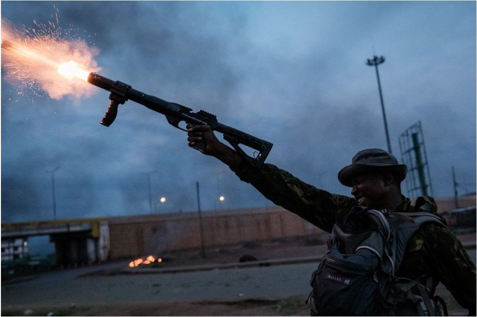 A Kenyan Police officer fires teargas towards supporters of the Azimio la Umoja-One Kenya Coalition Party in Kisuma after authorities announced William Ruto had beaten rival Raila Odinga to win the presidential elections on 15 August 2022