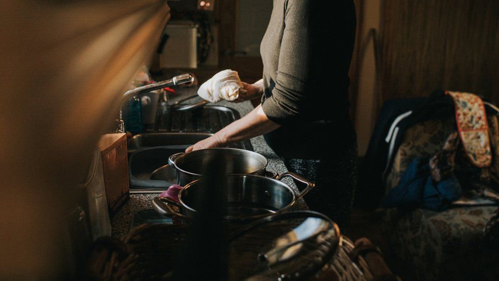 Woman at a kitchen sink stock image