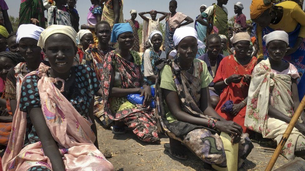 Women wait to receive food in South Sudan