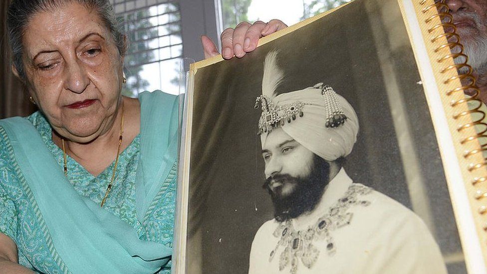 Amrit Kaur, the daughter of the late Maharaja of Faridkot- Harinder Singh Brar, poses with a portrait of the Maharaja at her residence in Chandigarh on August 2, 2013