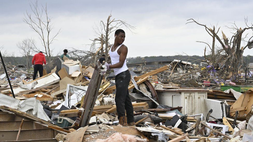 Residents clean up on 31 March after a tornado hit Rolling Fork, Mississippi