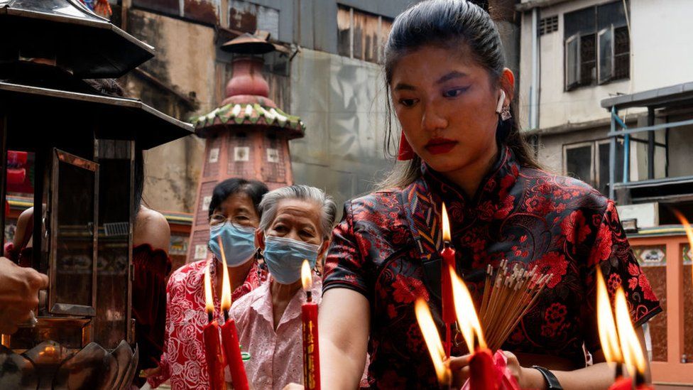 A woman prays at a temple of Yaowarat Chinatown on the first day of the Lunar New Year of The Dragon in Bangkok, Thailand, on February 10, 2024