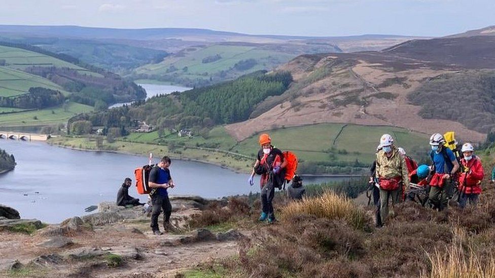 Injured climber carried away on stretcher