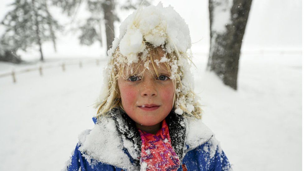 A child enjoys the snow in Yosemite National Park