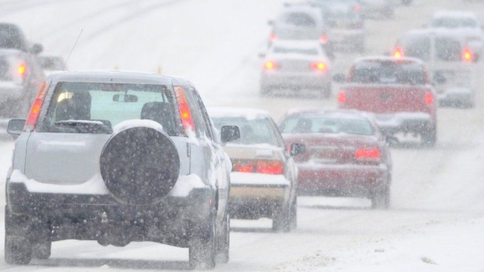 Cars driving on the motorway in heavy snow