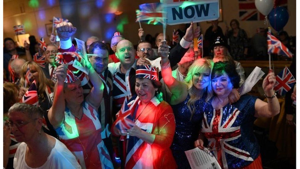Brexit supporters wave Union flags as the time passes 11 O"Clock at a Brexit Celebration party at Woolston Social Club in Warrington, north west England