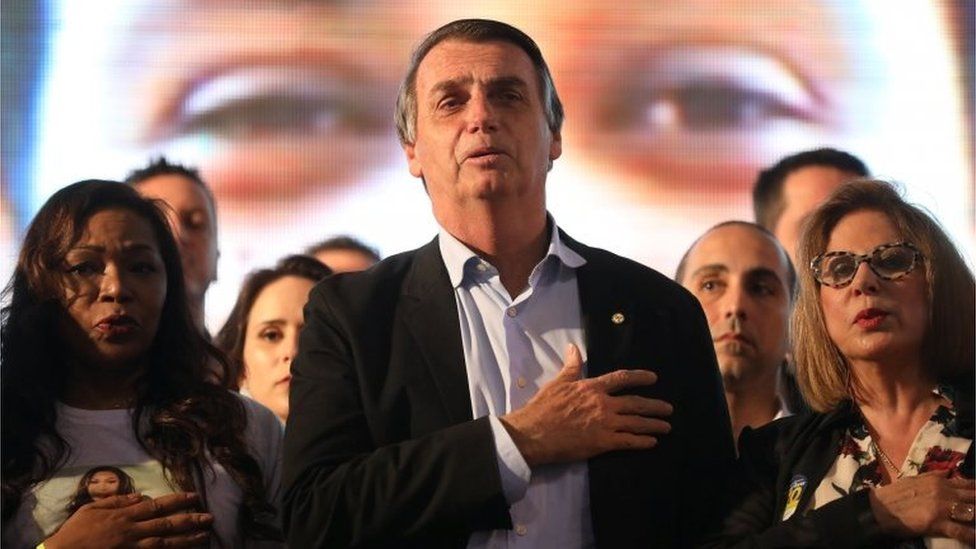 Presidential candidate Jair Bolsonaro listens to the national anthem during a meeting with women in Porto Alegre on 30 August, 2018.