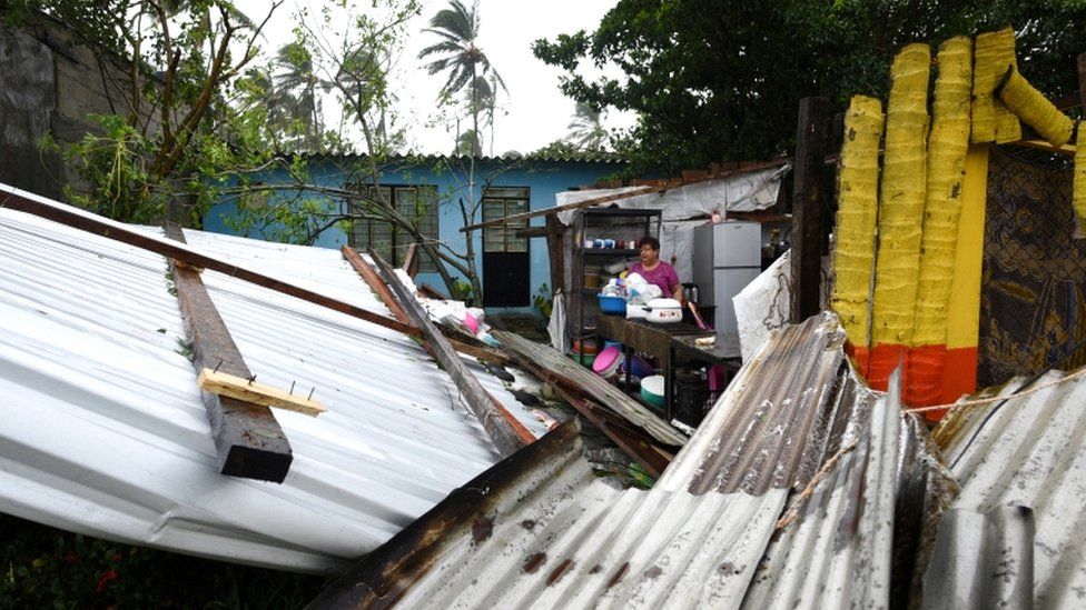 A woman stands amidst the debris of her home which was destroyed when Hurricane Grace slammed into the coast with torrential rains, in Costa Esmeralda, near Tecolutla, Mexico, 21 August 2021