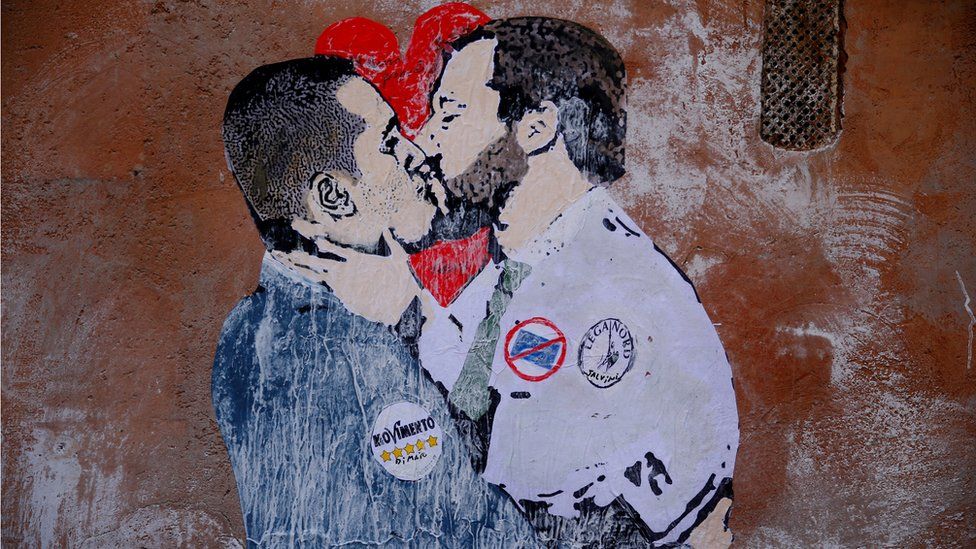 A mural depicting Northern League's leader Matteo Salvini (R) and 5-Star Movement leader Luigi Di Maio kissing is seen in Rome,