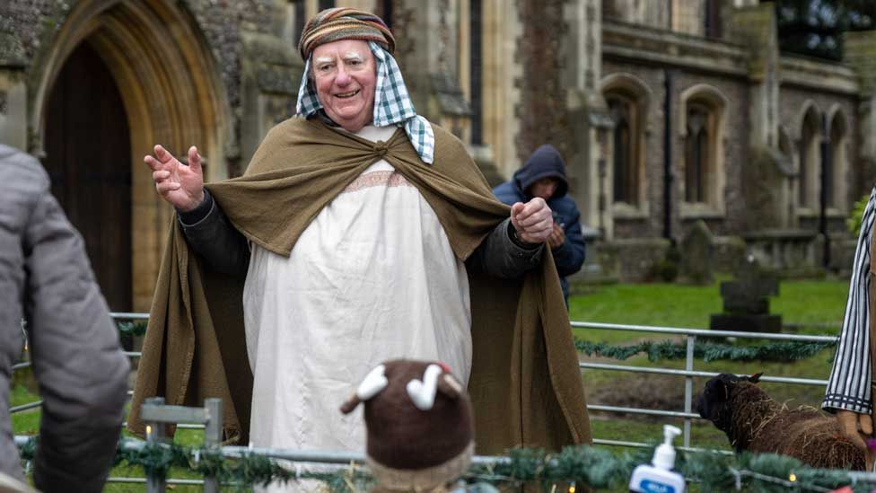 A shepherd with his sheep in the live nativity at St Albans Cathedral