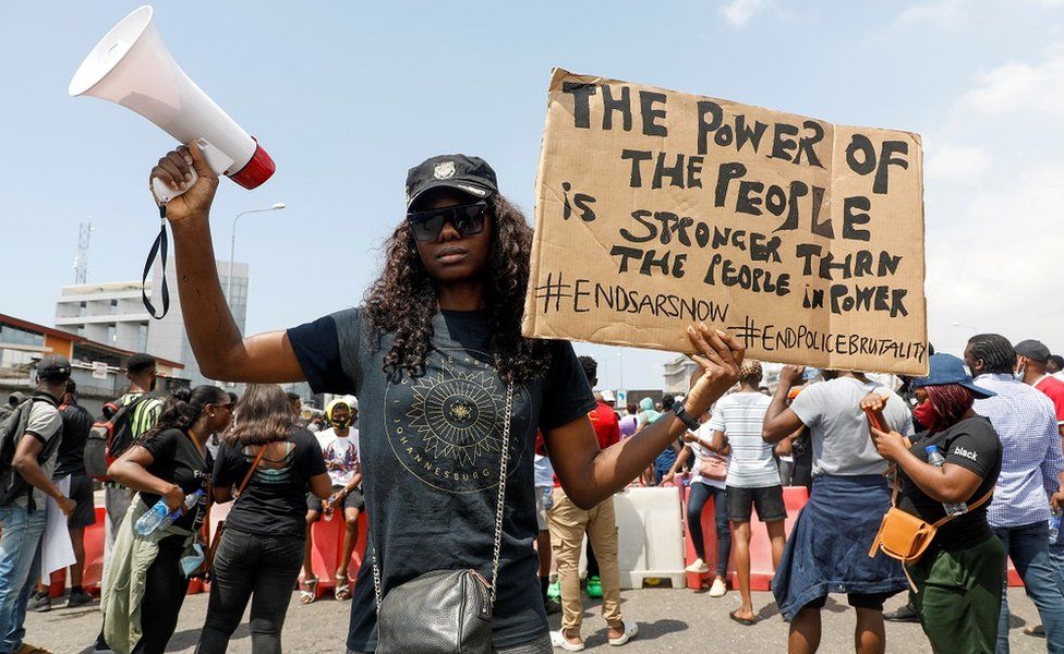 A demonstrator holds a banner during a protest against alleged police brutality, in Lagos, Nigeria