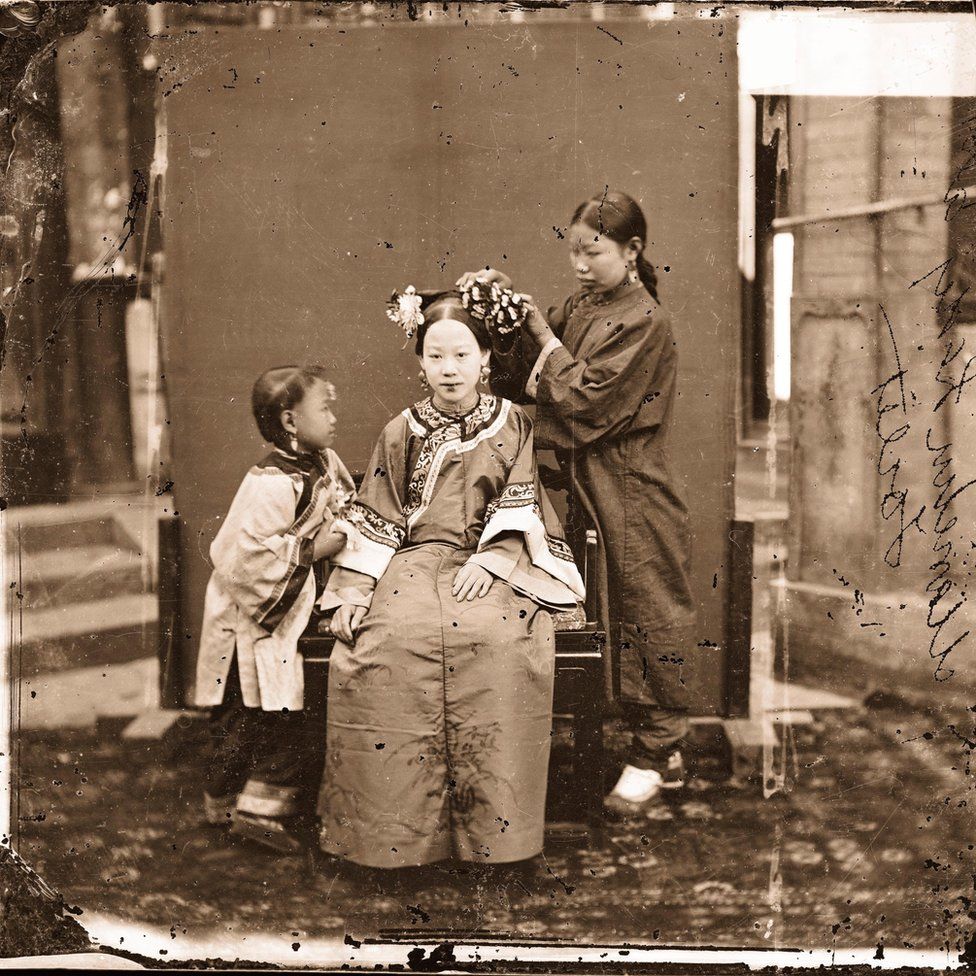 A Manchu Lady having her Hair dressed by a Servant Girl - Beijing 1871–72