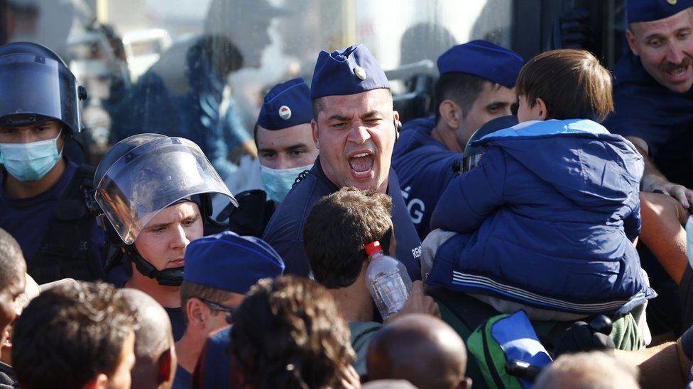 Hungarian police are helping take migrants to registration centres
