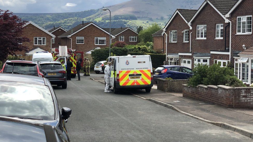 Fire and police investigators at the house fire in Abergavenny