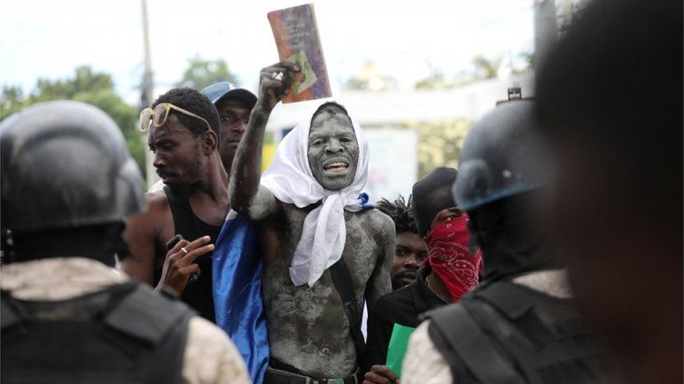 Demonstrators face police during protests demanding that the government of Prime Minister Ariel Henry do more to address gang violence including constant kidnappings, in Port-au-Prince, Haiti March 29, 2022