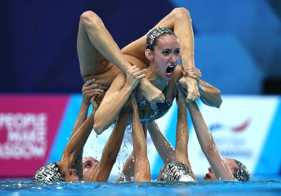 Swimmers compete in the Synchronised Swimming Team Free Routine final