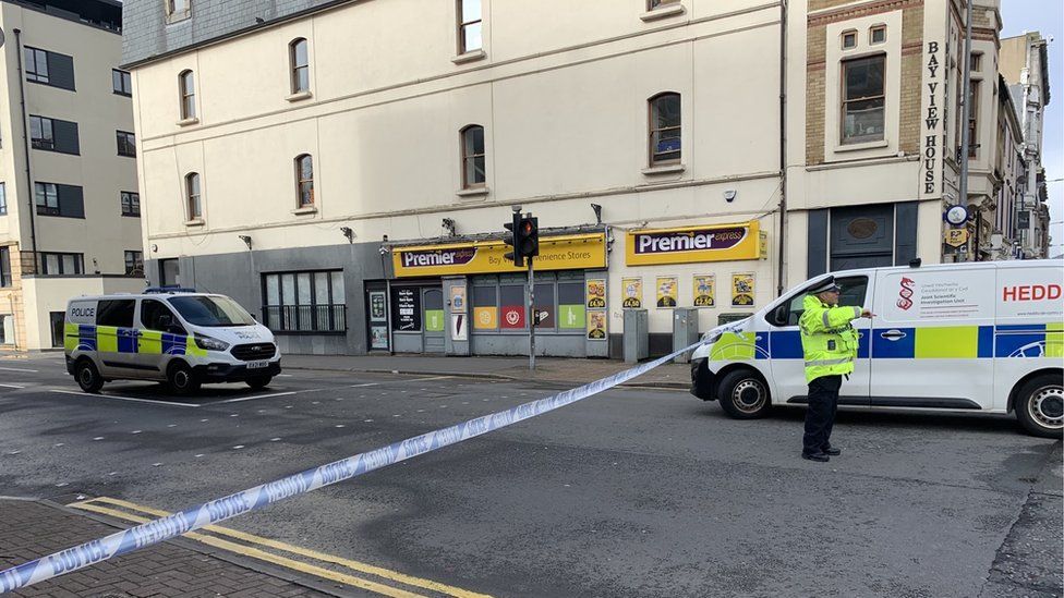 Police on closed road with police tape