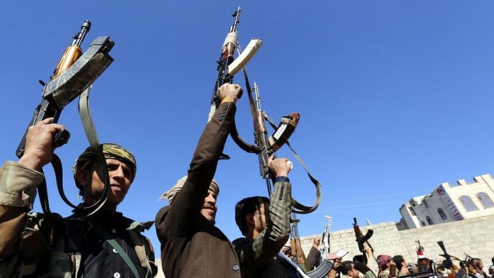 Houthi supporters hold up weapons in Sanaa, Yemen. Photo: 13 December 2018