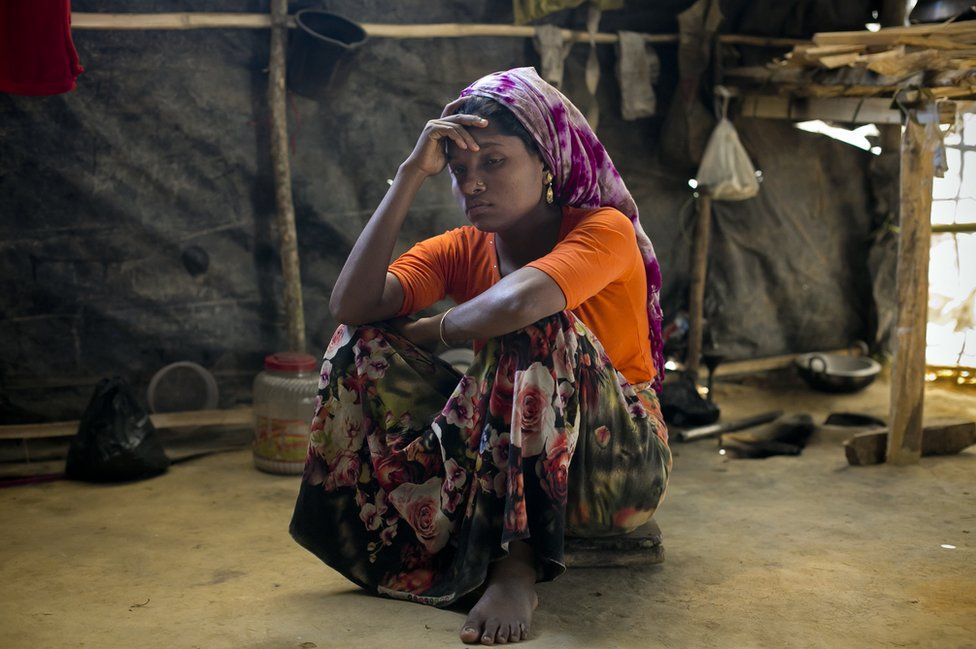 A Rohingya woman in the makeshift house she shares with 6 other refugees at a refugee camp in Cox's Bazar, Bangladesh.