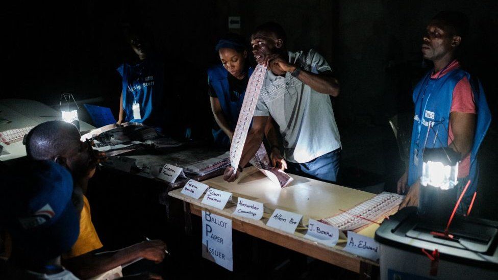 Election officials count the ballots of the general elections at a polling station in Monrovia on October 10, 2023. More than 2.4 million people were registered to vote in the West African nation, choosing their 73 representatives and 15 senators in addition to the president.