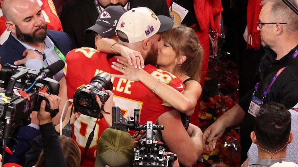Taylor Swift and Travis Kelce kiss after the Super Bowl