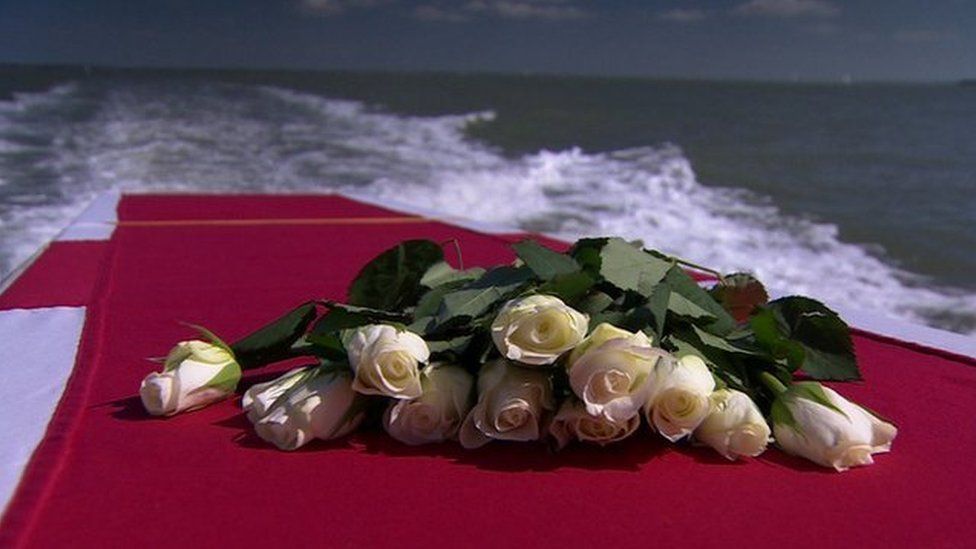 Roses placed on top of a coffin