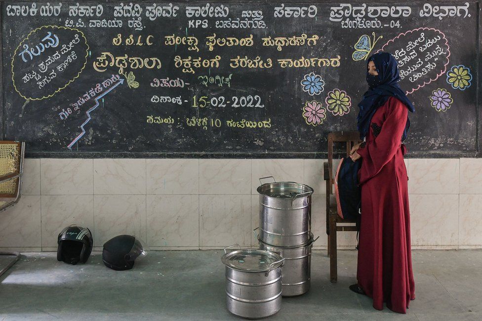 A student stands during the morning prayers at a government high school and pre-university college for women in Bangalore on February 16, 2022, after schools reopened in southern India under tight security after authorities banned public gatherings following protests over Muslim girls wearing the hijab in classrooms.