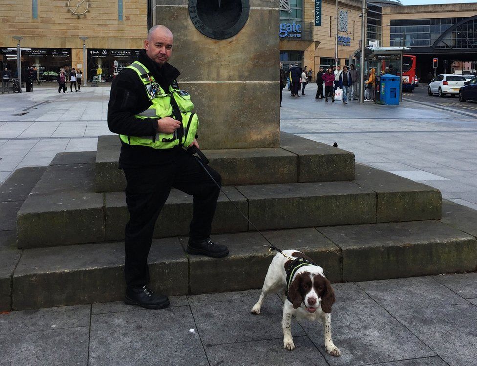 Police officer with sniffer dog in Inverness