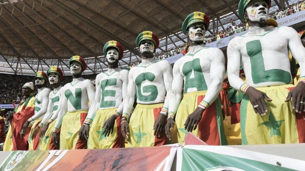 Senegalese football fans painted in the national colours.