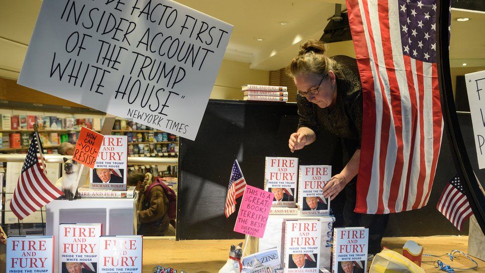A staff member displays copies of Michael Wolff's book on President Trump's Presidency 'Fire and Fury'