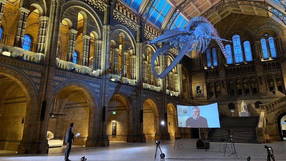 Justin Rowlatt conducting interview with Bill Gates at the Natural History Museum in London